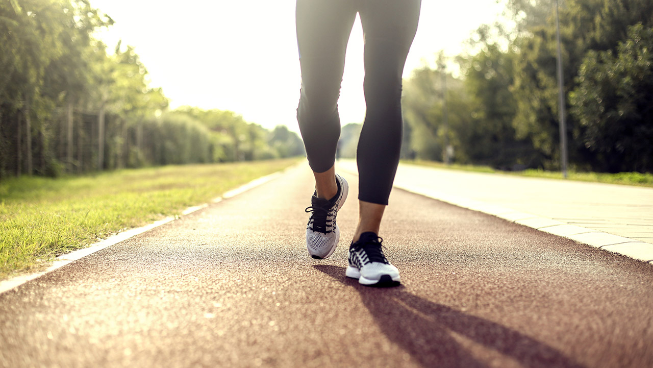 Young woman walking on a road