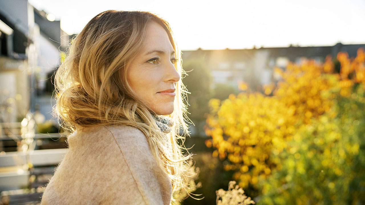 Young woman sitting outside wearing a sweater