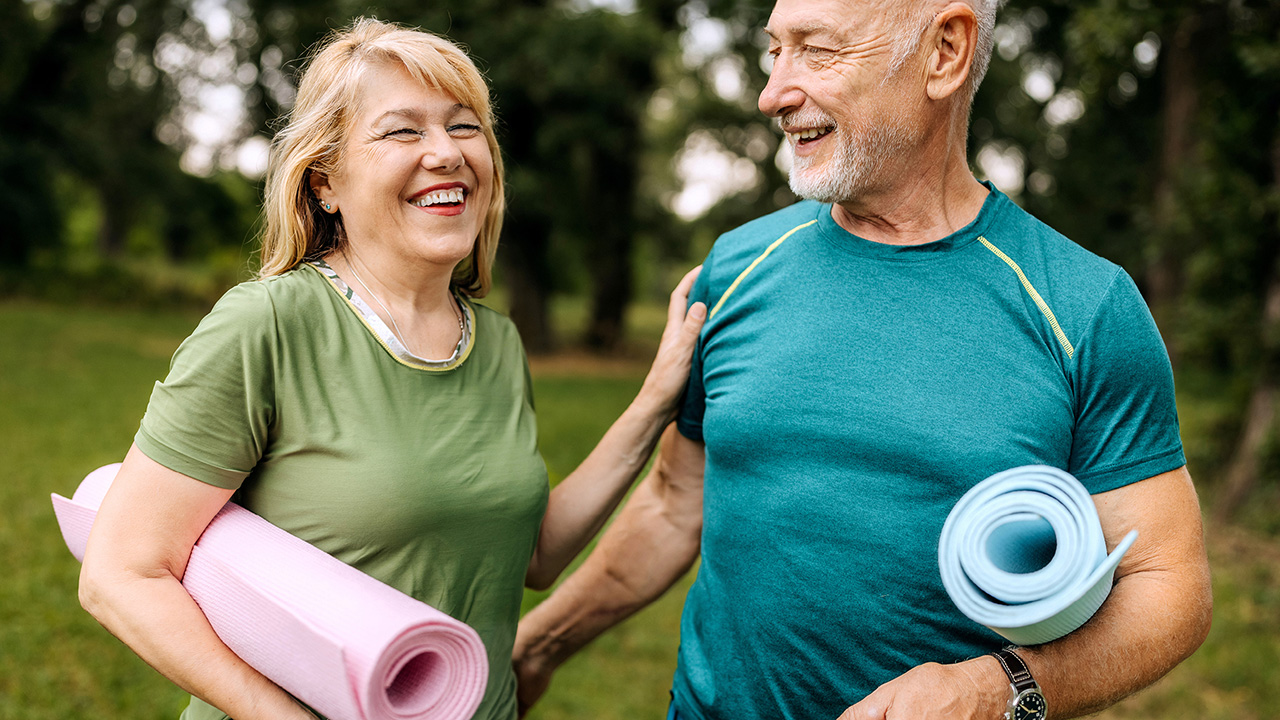 happy couple with yoga mats