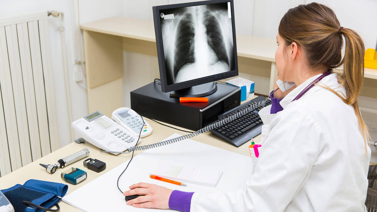 Radiologist looking at an xray on her computer screen
