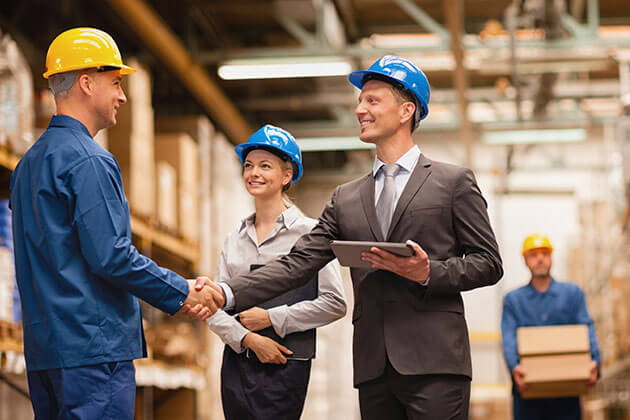 group of employees have a meeting in warehouse