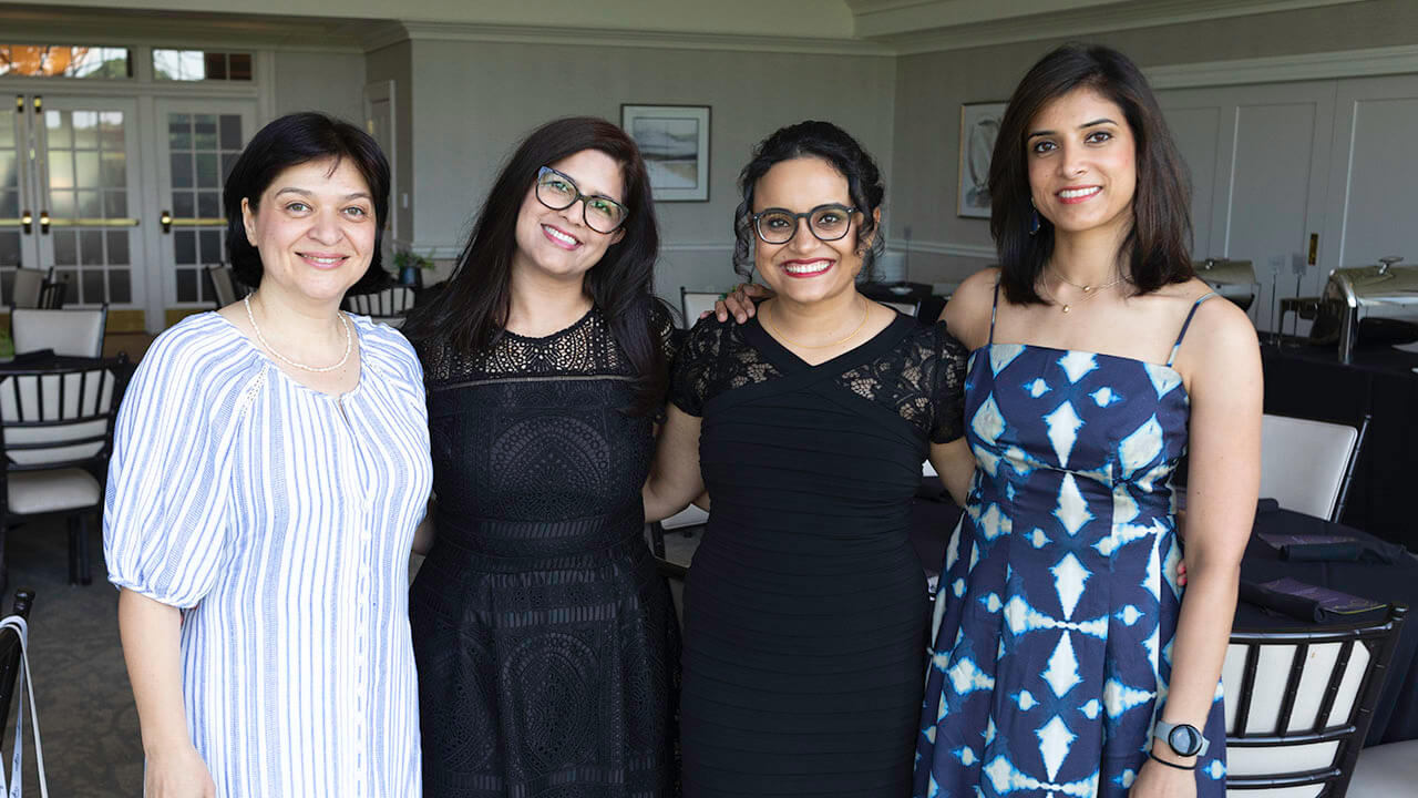 Four resident graduates standing next to each other