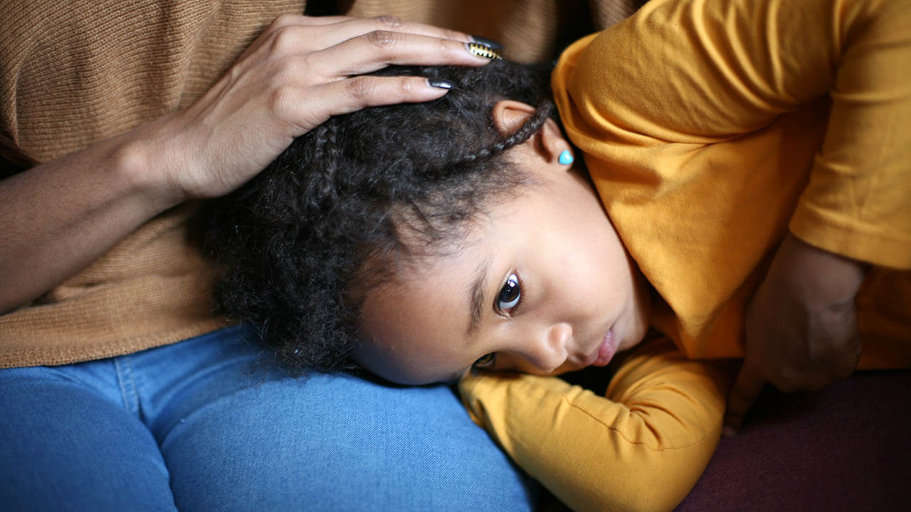 Young girl laying on mom's lap