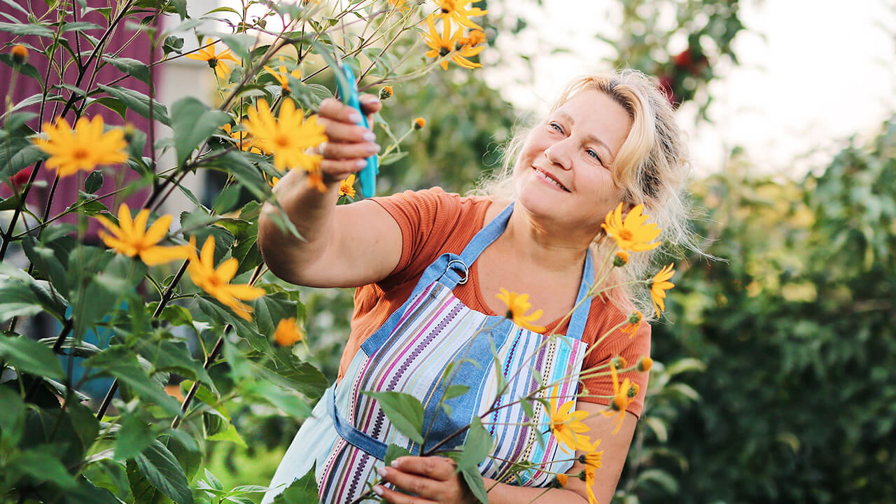 Middle aged woman surrounded by spring flowers