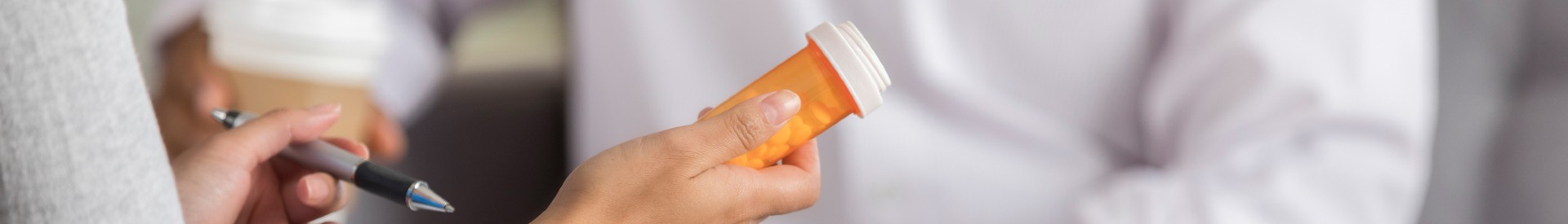 Prescriber Examining Drug Bottle
