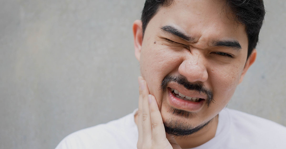 Patient with TMJ holding jaw